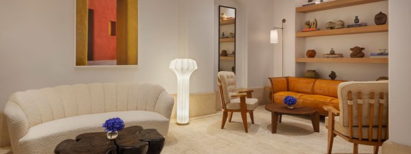 Hotel lobby with seating areas, artwork and decorated bookshelves.