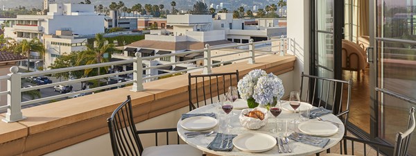 Large dining table on outdoor balcony overlooking Beverly Hills