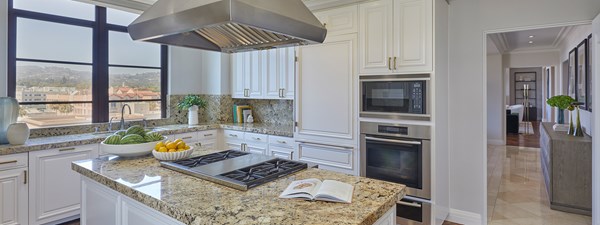 Spacious kitchen with marble island in The Residence