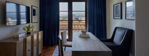 Wooden desk and chair in office looking out to the  L.A skyline in The Residence