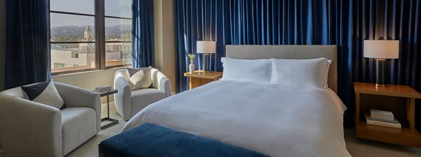 Guest bedroom with dark blue walls and king size bed in The Residence