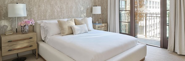 Second bedroom of the Three-bedroom Residence with white bedding and cream cushions on the bed